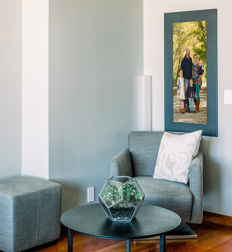 A cozy nook with a large portrait of a family from a family photo shoot in Alpharetta, Georgia